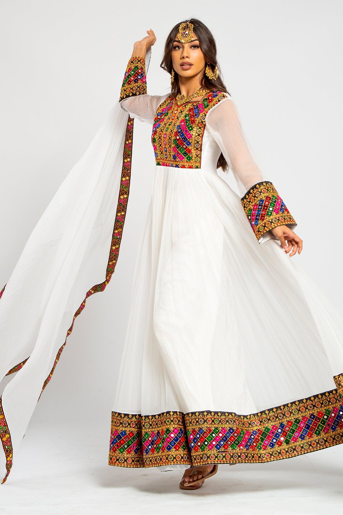 Model wearing an ivory Afghan dress with embroidered borders