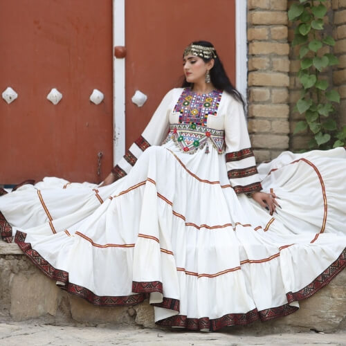 Ivory Afghan dress styled in a heritage courtyard